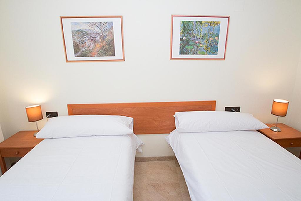 Posteľ alebo postele v izbe v ubytovaní Viveros Apartments