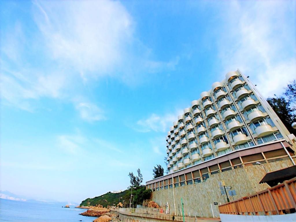 a large building on the shore of a body of water at Warwick Hotel Cheung Chau in Hong Kong