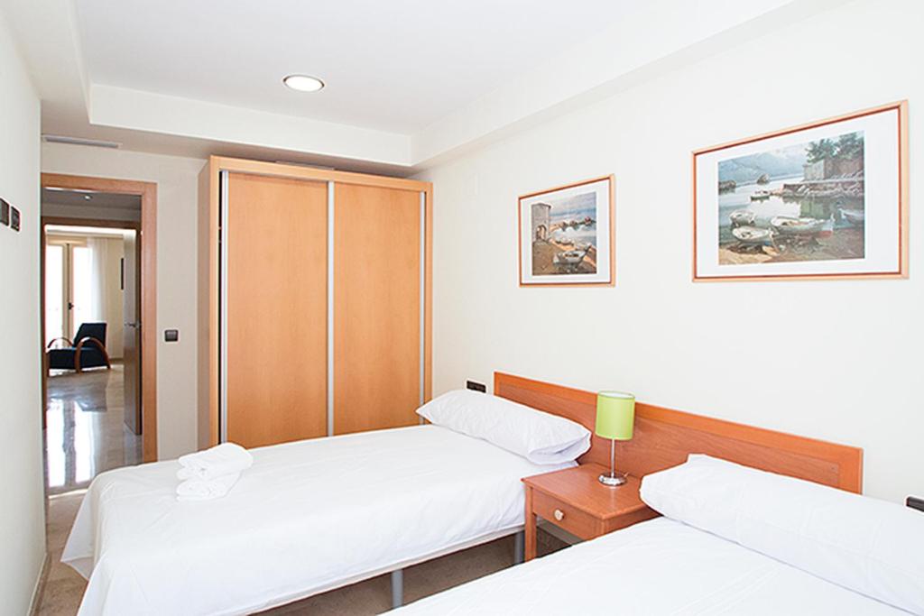 Posteľ alebo postele v izbe v ubytovaní Viveros Apartments