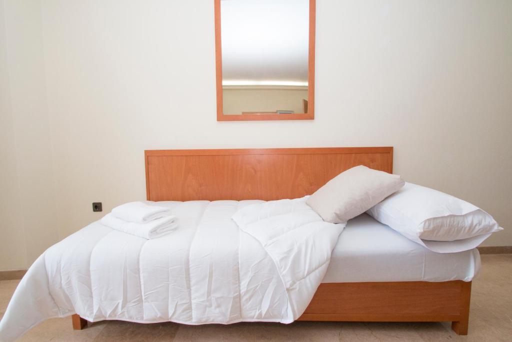 Posteľ alebo postele v izbe v ubytovaní Viveros Apartments