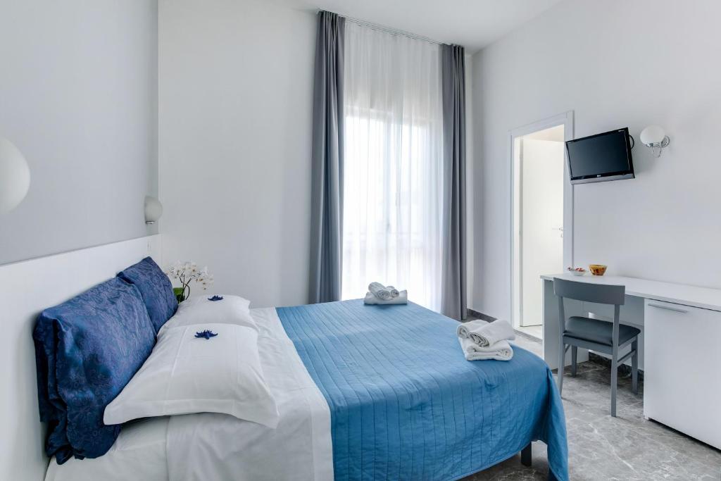 Postel nebo postele na pokoji v ubytování Hotel Quisisana