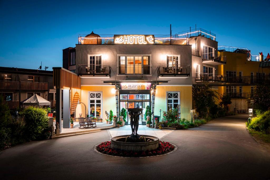 a building with a statue in front of it at Spirit & SPA Birkenhof am Elfenhain in Grafenwiesen