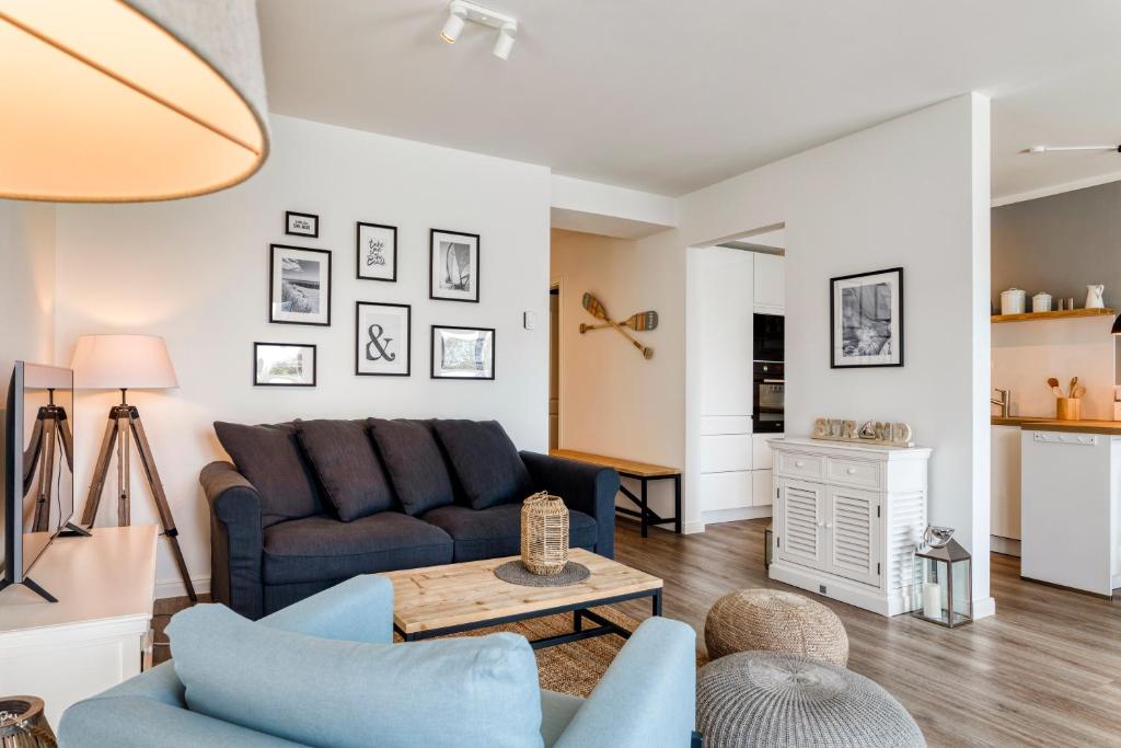 a living room with a couch and a table at 54' Nord Damp in Damp