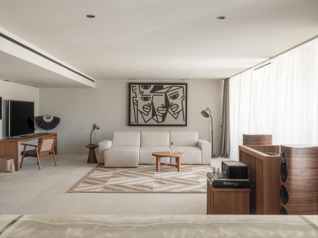 a living room with a couch and a table at OKU Ibiza in San Antonio