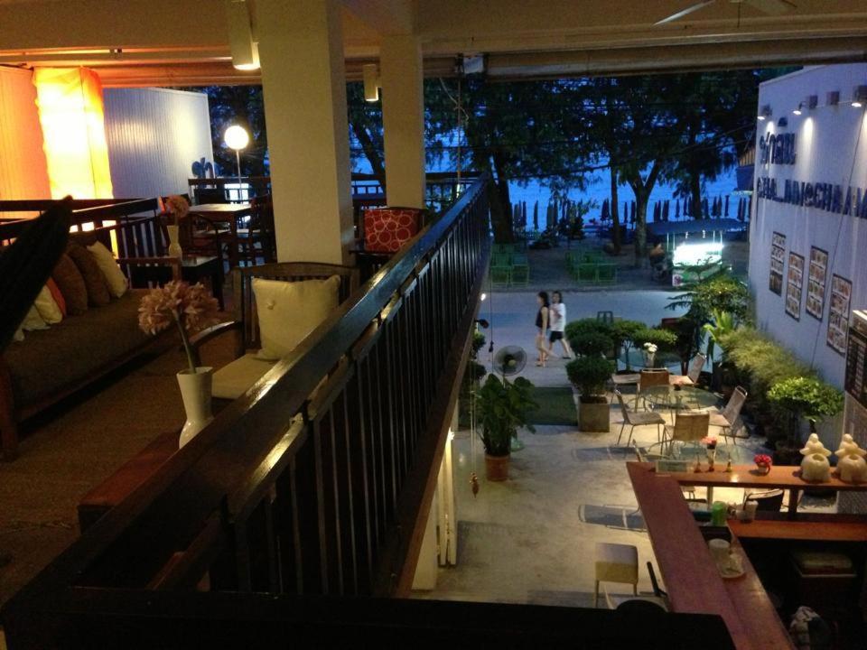 a lobby of a building with people walking on a street at Cha_Inn @ Cha Am in Cha Am