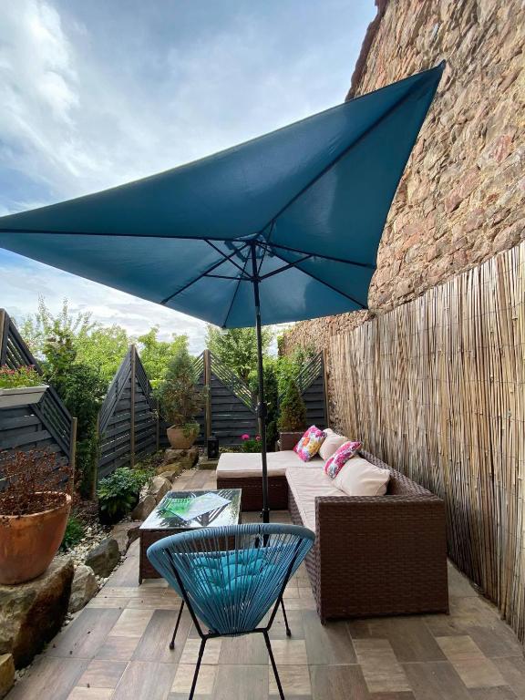 a blue umbrella sitting on top of a patio at Apartmány u sv. Michaela in Kadaň