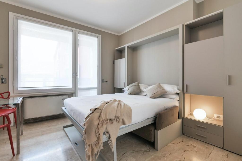 Postel nebo postele na pokoji v ubytování Contempora Apartments - Elvezia 8 - E31