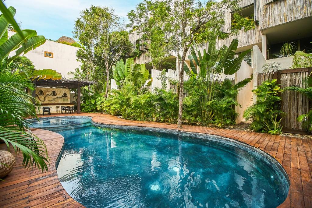 a swimming pool in the middle of a yard at Eco-chic Design Condos Wrapped in Nature's Elements by Stella Rentals in Tulum