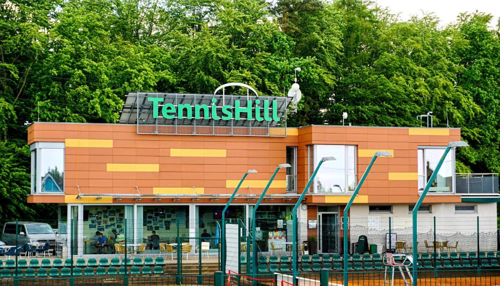 a building with a sign on top of it at TennisHill Havířov in Havířov