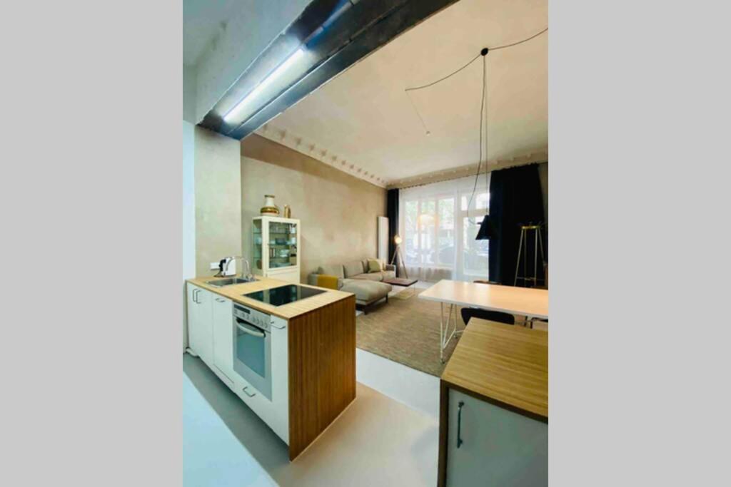 a kitchen with a sink and a stove top oven at Wunderschöne Ladenwohnung in Kreuzberg in Berlin
