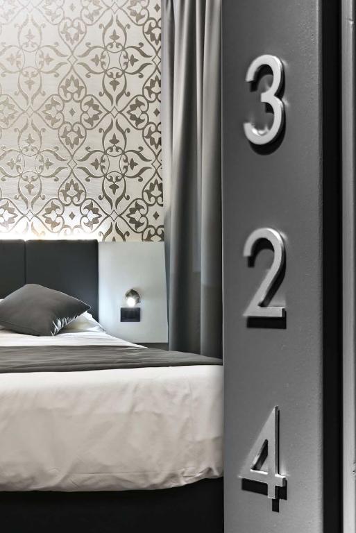 Łóżko lub łóżka w pokoju w obiekcie Ilga Hotel