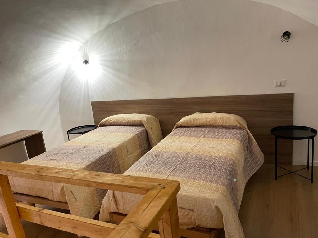A bed or beds in a room at Il Vicolo Home 2