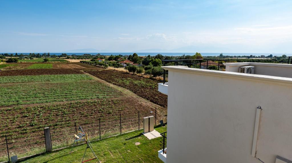 a view of a field from the balcony of a house at Mythic Villas in Epanomi