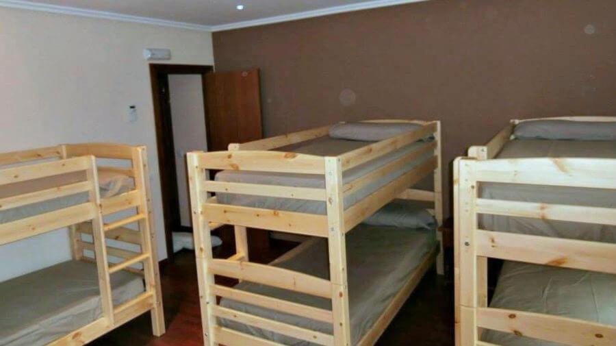 a room with three bunk beds in it at Albergue Buen Camino in Navarrete