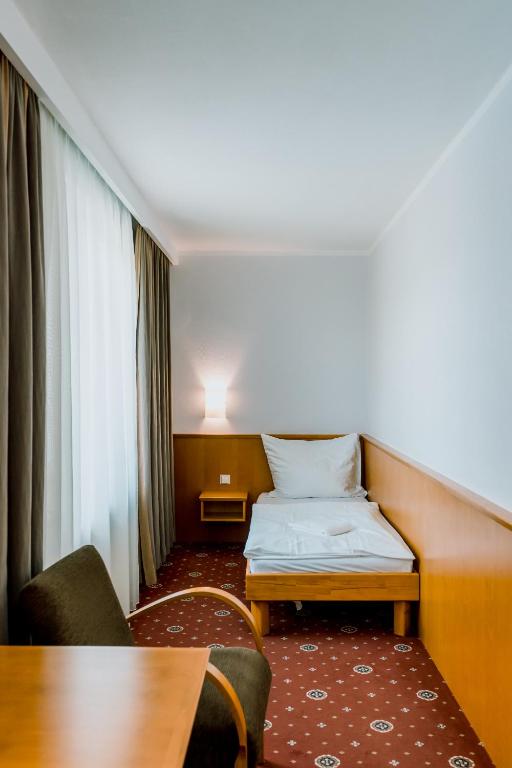 Postel nebo postele na pokoji v ubytování Prachárna Park Hotel Olomouc