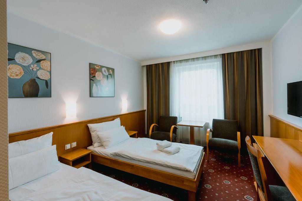 Postel nebo postele na pokoji v ubytování Prachárna Park Hotel Olomouc