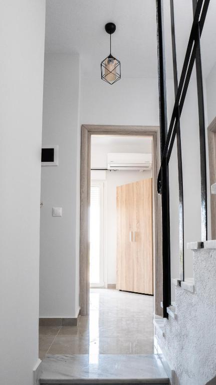 an open hallway with a door to a room with white walls at Mythic Villas in Epanomi