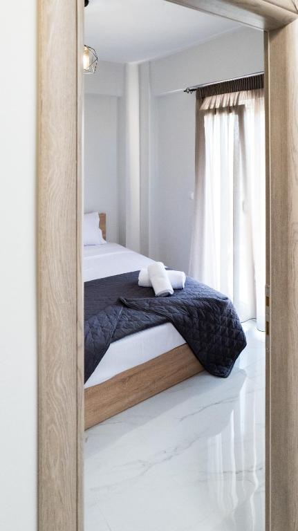 a bedroom with a bed and a mirror at Mythic Villas in Epanomi