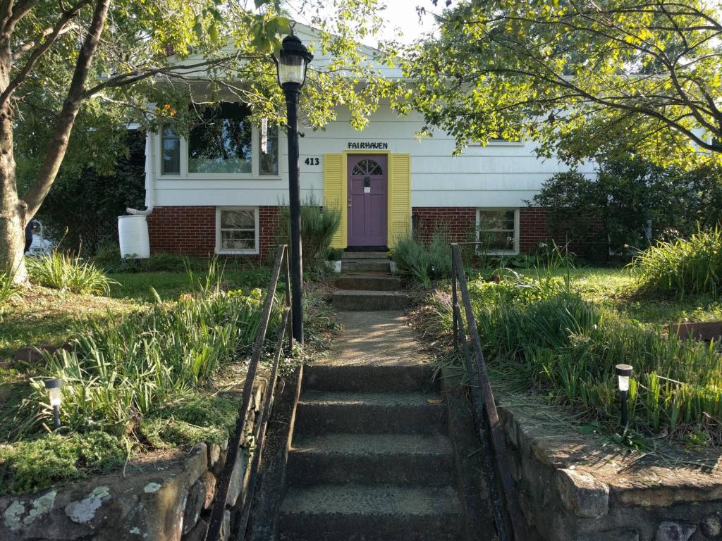 a house with a purple door and stairs at Fairhaven Guesthouse in Charlottesville