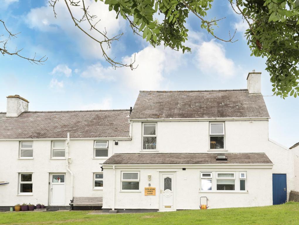 a white house with a grey roof at Bodlasan Groes House in Holyhead