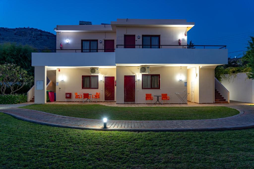 a house with a lawn in front of it at Angela Studios Pefkos in Pefki