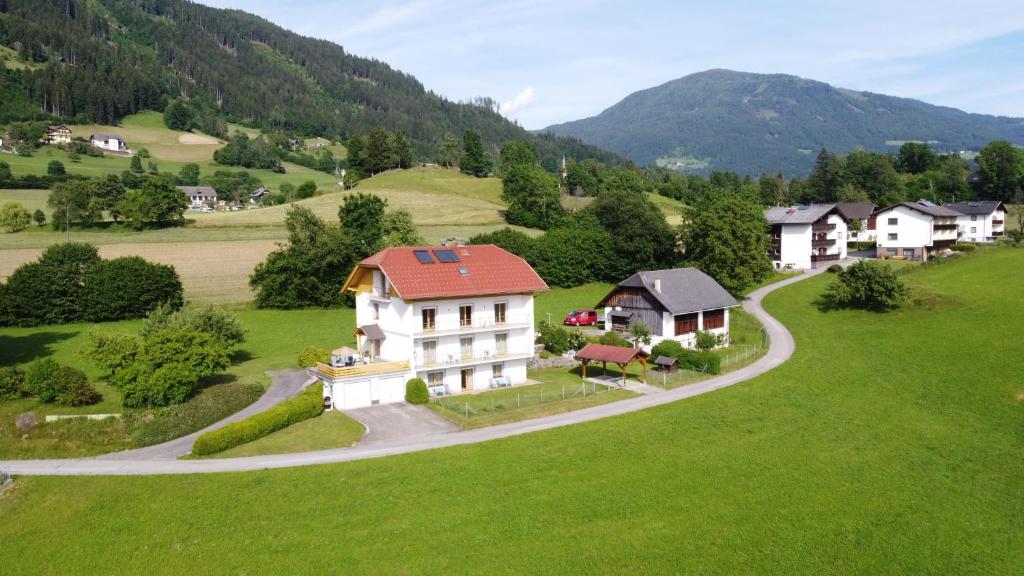 an aerial view of a house in a green field at Haus Moser in Millstatt