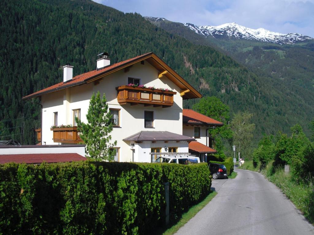 a house with a balcony on the side of a road at Haus Grünbacher in Lienz