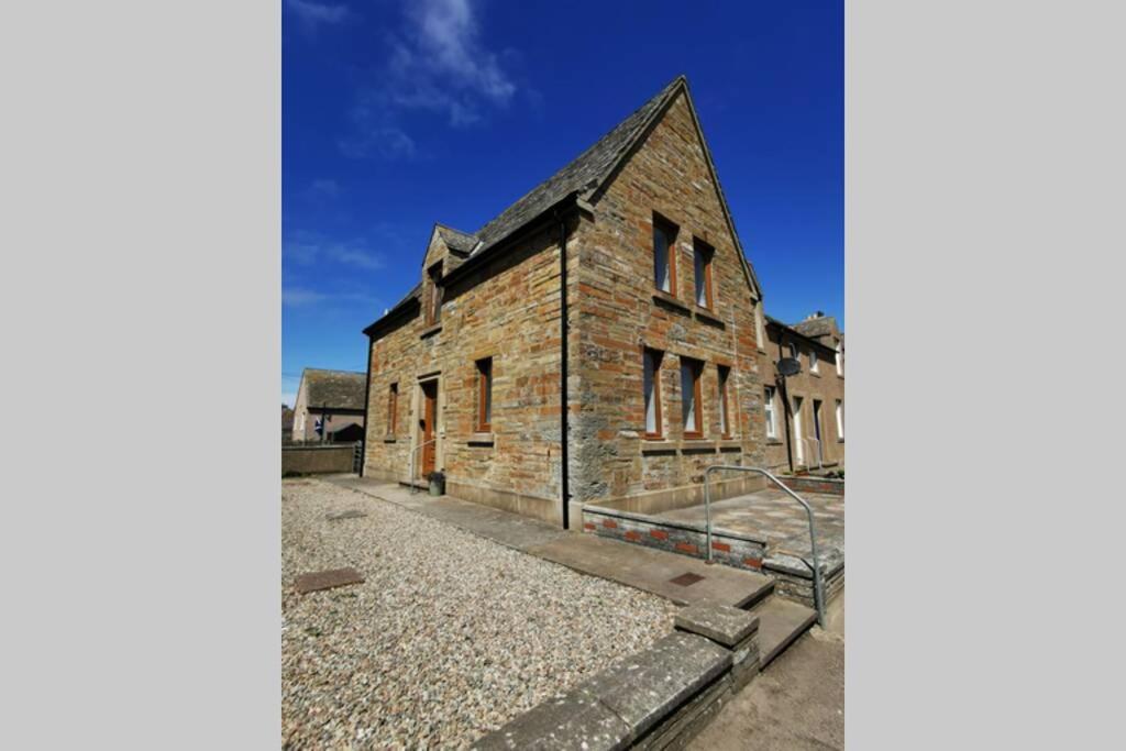 an old brick building with a blue sky in the background at Angus House, 2 Bedroom House, Thurso, NC500 Route in Thurso