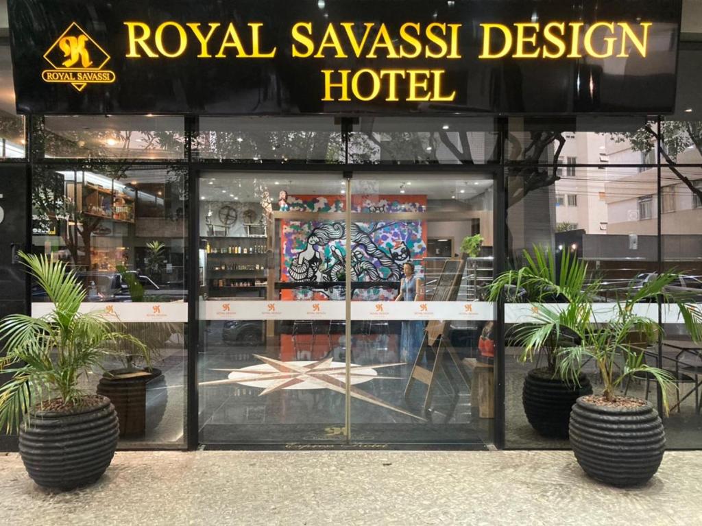 a hotel with potted plants in front of a window at Royal Design Savassi Hotel in Belo Horizonte