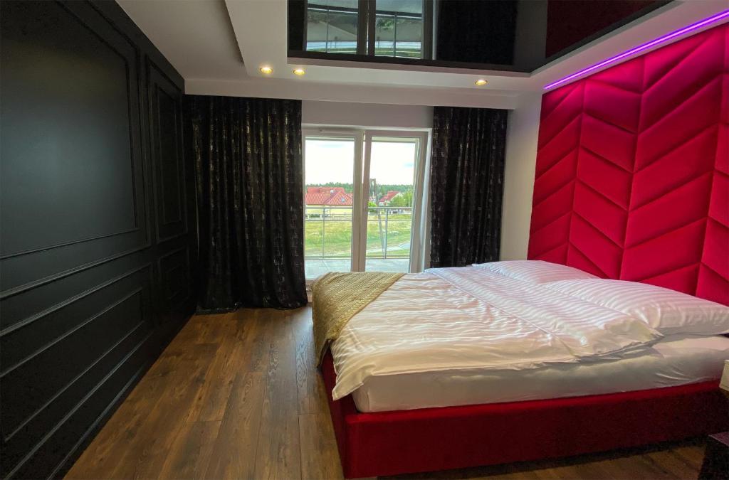 Posteľ alebo postele v izbe v ubytovaní Apartament Szot