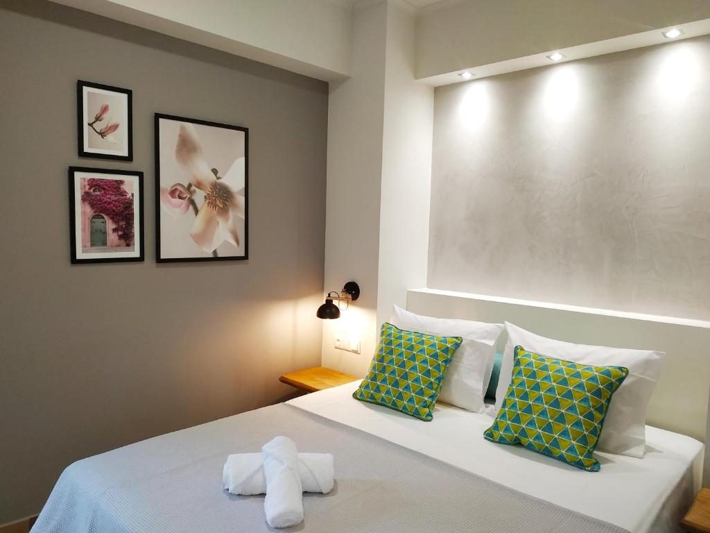 a bedroom with a bed with two towels on it at SUNNY DAYS in Limenaria