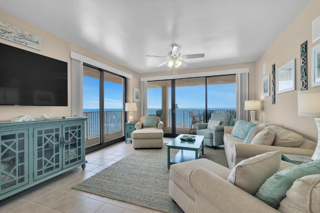 a living room with a couch and a tv at Windward Pointe Unit 901 in Orange Beach