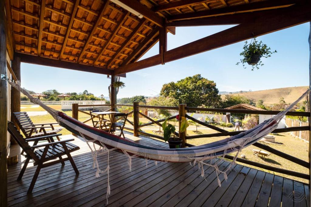 a hammock on a deck with a view at Pousada Sons do Silêncio in Socorro