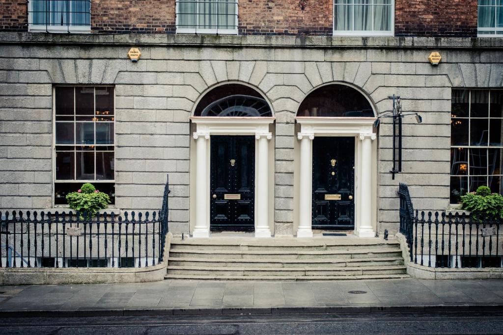 a building with two doors and stairs in front at Albany House in Dublin