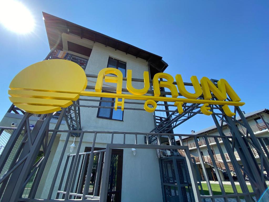 a yellow sign on the side of a building at AURUM-hotel in Berdyansʼk