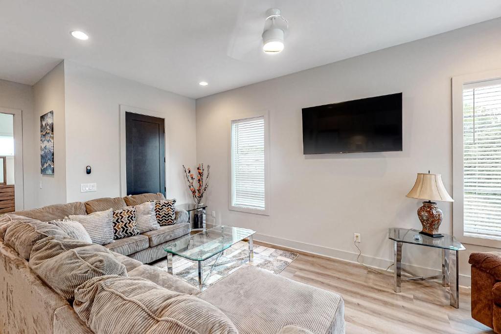 a living room with a couch and a tv at Gem of Music City in Nashville