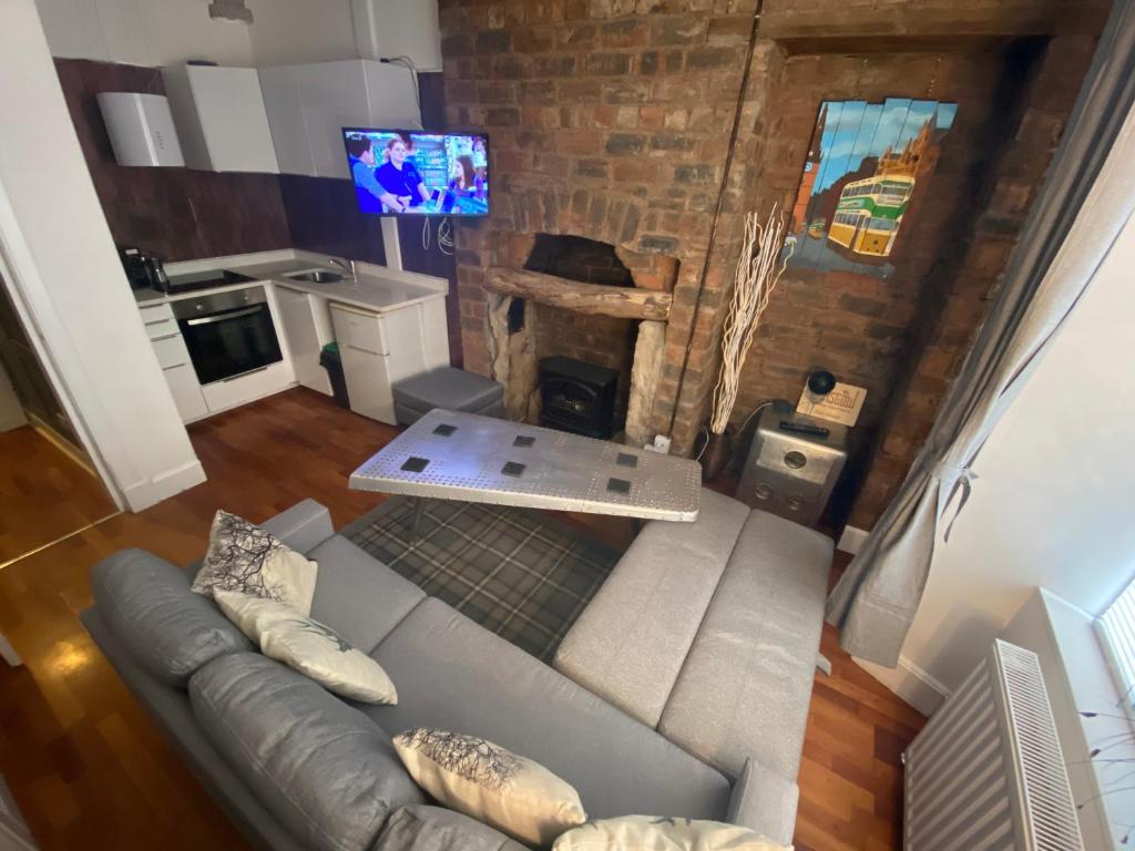 an overhead view of a living room with a couch and a fireplace at Glasgow City Centre Apartment in Glasgow