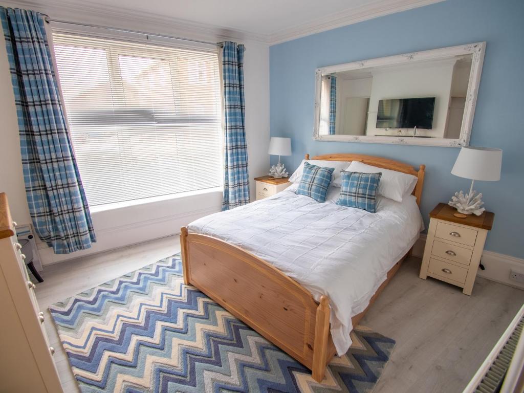 a bedroom with a bed and a large window at North Bay Holiday Apartment with Internet, Smart TV's and Patio Area in Scarborough