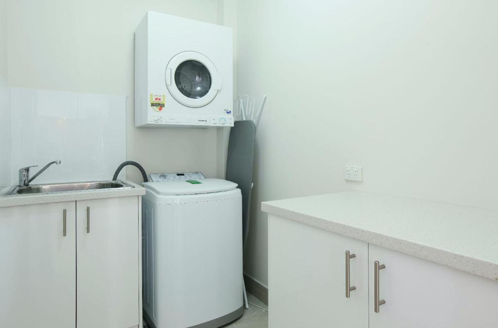 a laundry room with a washing machine and a dryer at The Breakers in Gold Coast
