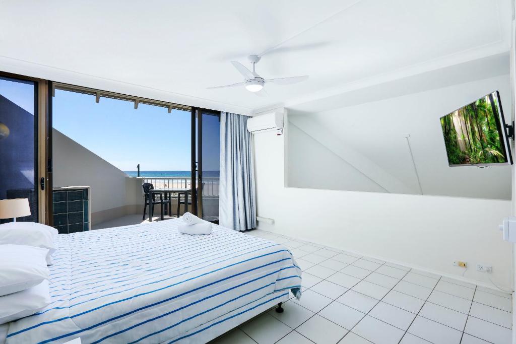 a bedroom with a bed and a view of the ocean at The Breakers in Gold Coast
