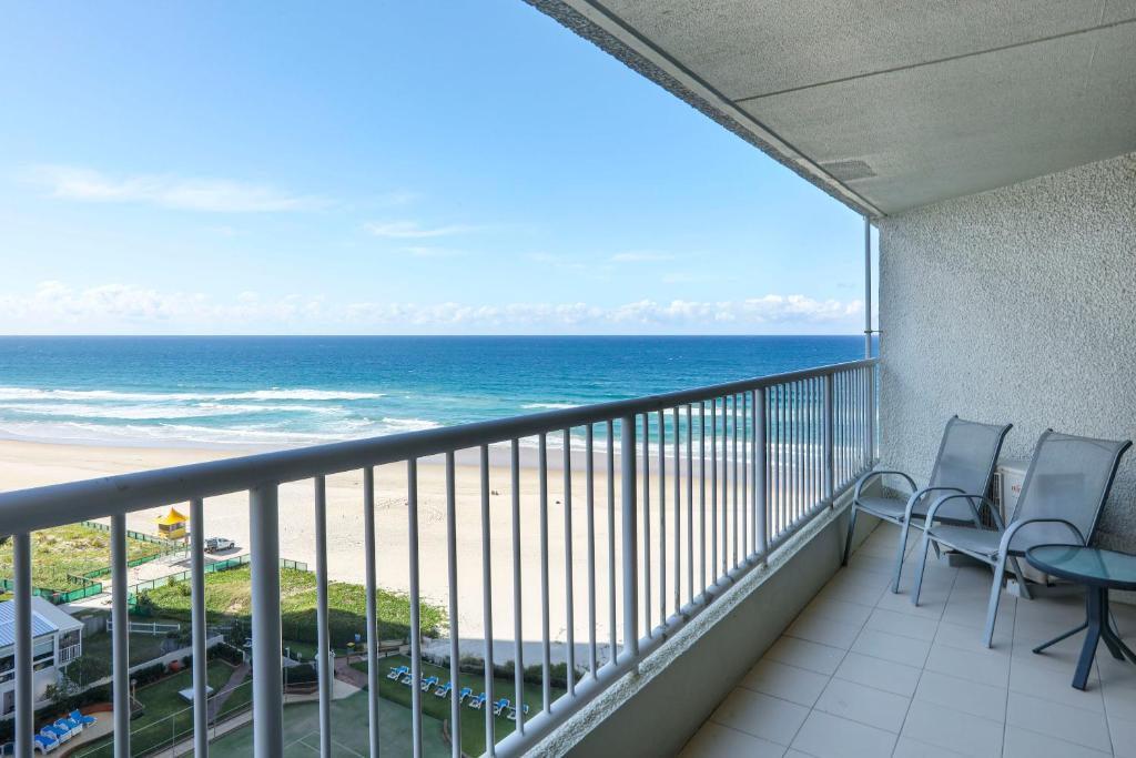 a balcony with chairs and a view of the ocean at The Breakers in Gold Coast