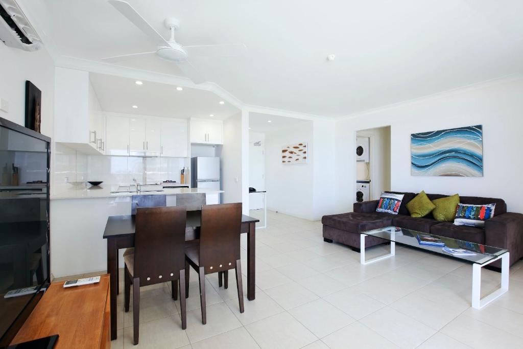 a kitchen and living room with a table and a couch at The Breakers in Gold Coast