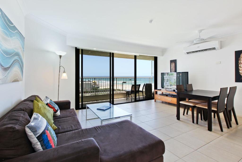 a living room with a couch and a table at The Breakers in Gold Coast