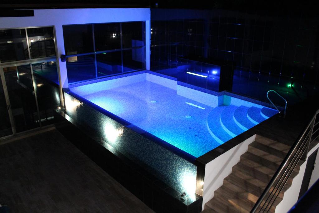 a swimming pool at night with blue lights at Casa Balam Gladiolas in Cancún