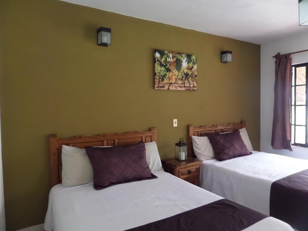 Postel nebo postele na pokoji v ubytování Hotel Casa de Vino