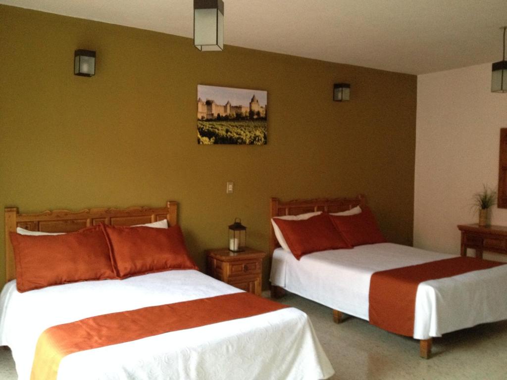 Postel nebo postele na pokoji v ubytování Hotel Casa de Vino