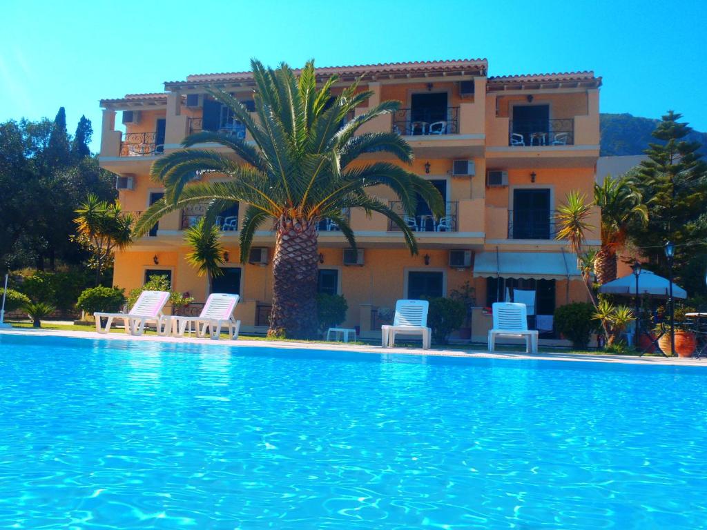 a large swimming pool in front of a building at RoyalRose in Paleokastritsa