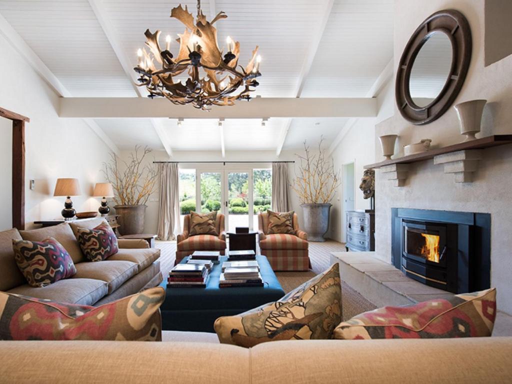 a living room with a couch and a fireplace at Paul Bangay The Farmhouse in Denver