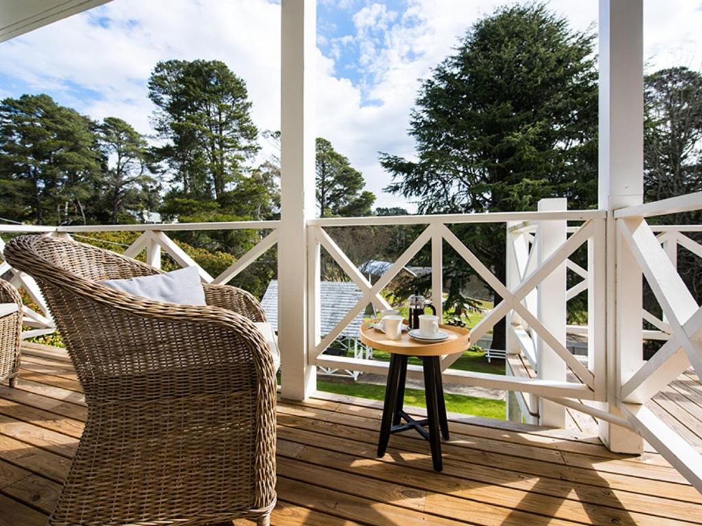a patio with chairs and a table on a porch at Lake Daylesford Apartments 2A in Daylesford