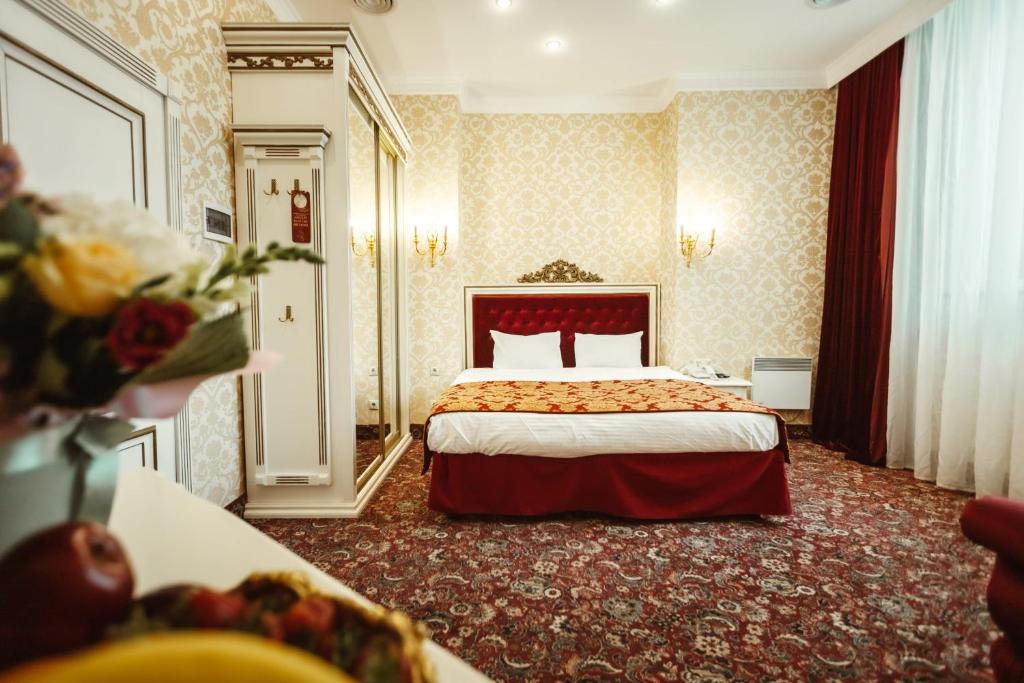 a hotel room with a bed in the middle of it at De Paris Hotel in Kyiv